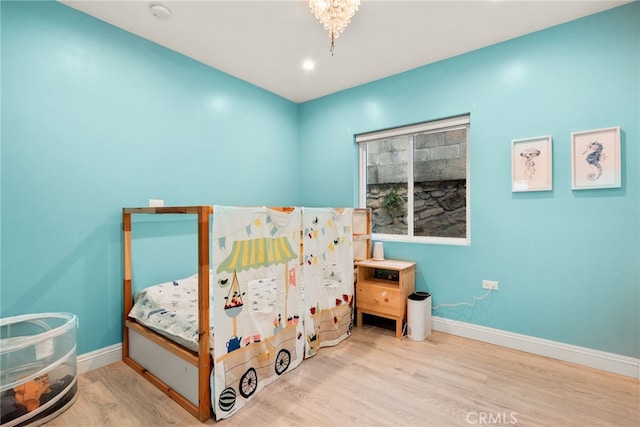 bedroom with wood finished floors and baseboards