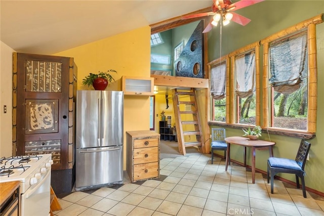 5338 Deception River Rd, Chico, CA 95928 - kitchen with freestanding refrigerator, gas range gas stove, light tile patterned floors, a ceiling fan, and baseboards