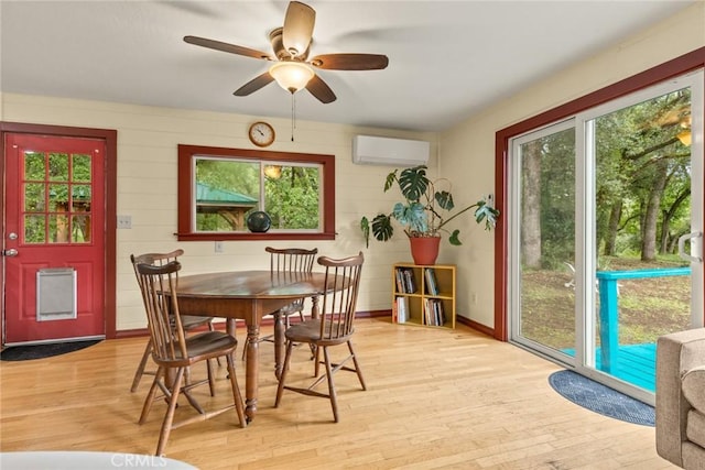 5338 Deception River Rd, Chico, CA 95928 - dining room with a wall mounted AC, light wood-style floors, a ceiling fan, and baseboards