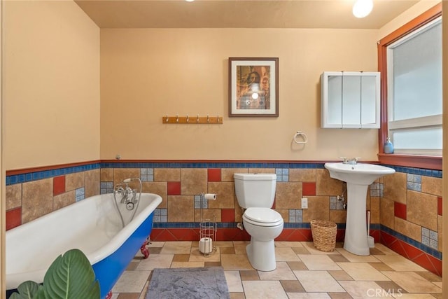 5338 Deception River Rd, Chico, CA 95928 - bathroom with tile walls, toilet, a freestanding bath, and wainscoting