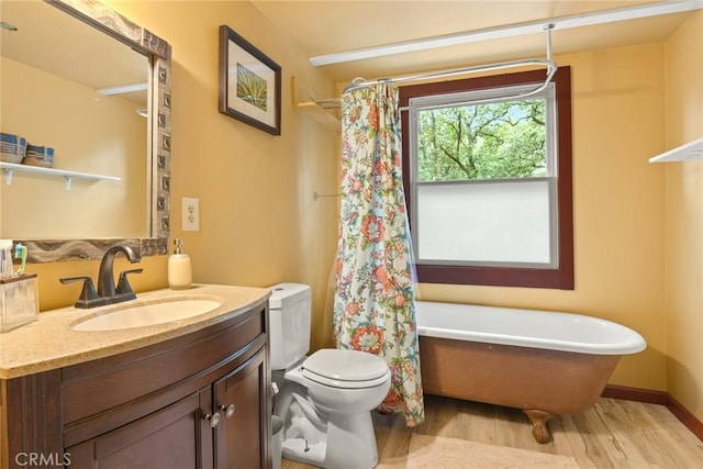 5338 Deception River Rd, Chico, CA 95928 - bathroom with wood finished floors, a freestanding tub, toilet, vanity, and a shower with shower curtain