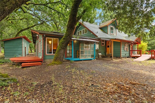 5338 Deception River Rd, Chico, CA 95928 - back of house with a sunroom, a wooden deck, an outbuilding, a shed, and a shingled roof