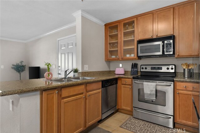 2045 Las Colinas Cir Unit 103, Corona, CA 92879 - kitchen with appliances with stainless steel finishes, a sink, ornamental molding, brown cabinetry, and glass insert cabinets