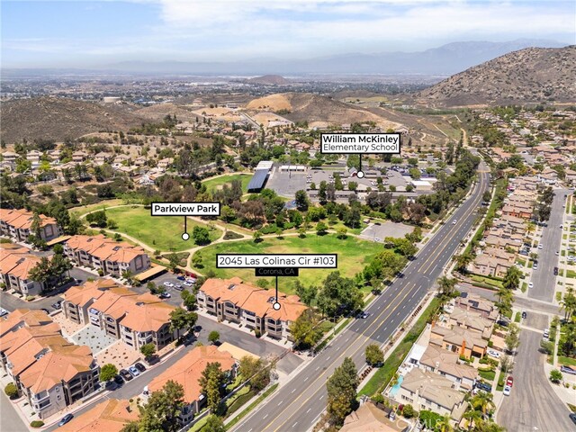 2045 Las Colinas Cir Unit 103, Corona, CA 92879 - aerial overview of property's location featuring a mountainous background and nearby suburban area