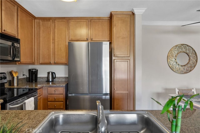 2045 Las Colinas Cir Unit 103, Corona, CA 92879 - kitchen featuring appliances with stainless steel finishes, crown molding, brown cabinets, a sink, and dark stone countertops