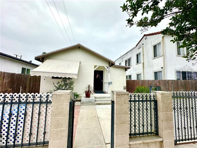 140 S Vendome St, Los Angeles, CA 90057 - view of front facade featuring a fenced front yard, stucco siding, and a gate