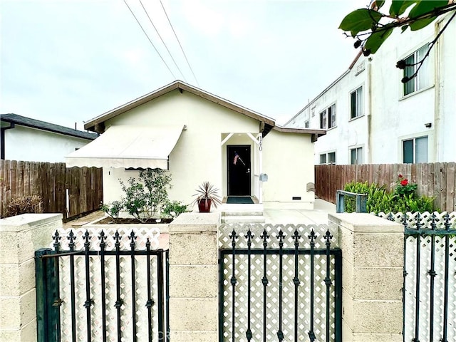 140 S Vendome St, Los Angeles, CA 90057 - view of front of property with a gate, a fenced front yard, and stucco siding