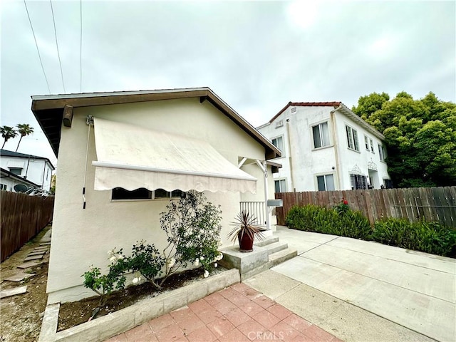 140 S Vendome St, Los Angeles, CA 90057 - view of side of property with a patio area, stucco siding, and fence