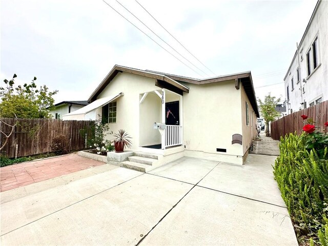 140 S Vendome St, Los Angeles, CA 90057 - rear view of property with a patio area, fence, stucco siding, and crawl space