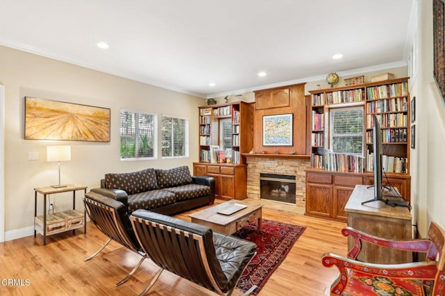 856 E Rio Grande St, Pasadena, CA 91104 - living room featuring crown molding, light wood-style flooring, a stone fireplace, recessed lighting, and baseboards