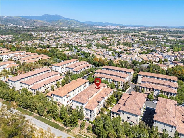 aerial view of property and surrounding area with mountains