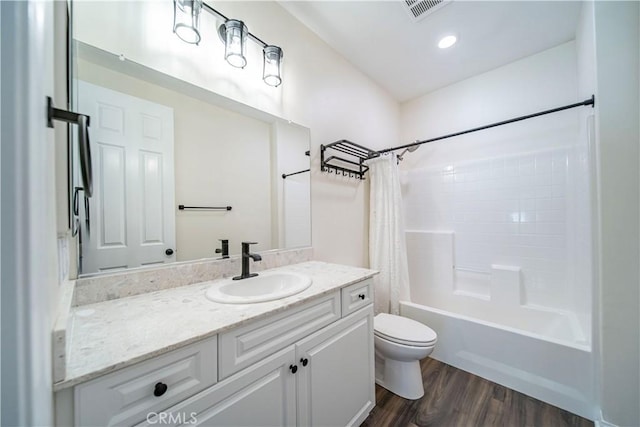 full bath featuring toilet, wood finished floors, shower / bathtub combination with curtain, and vanity