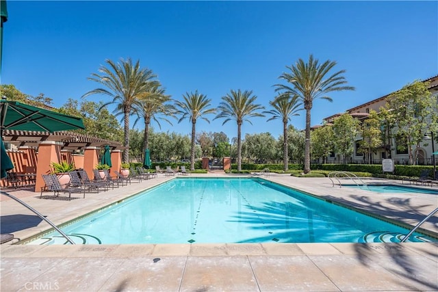 community pool with a patio area