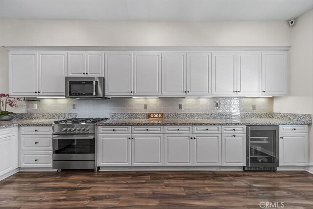 135 Neptune, Irvine, CA 92618 - kitchen featuring beverage cooler, appliances with stainless steel finishes, white cabinetry, and decorative backsplash