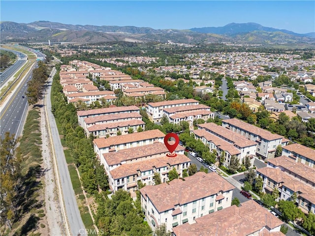 aerial view of property and surrounding area with mountains