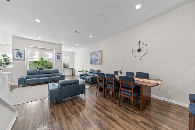 living room with wood finished floors, baseboards, and recessed lighting