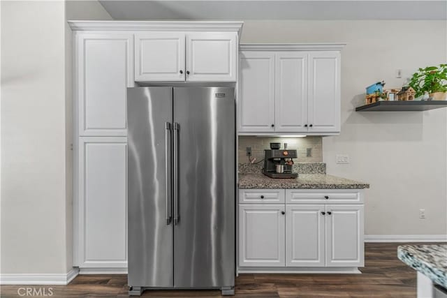 135 Neptune, Irvine, CA 92618 - kitchen featuring high end fridge, dark wood-type flooring, light stone counters, backsplash, and white cabinetry