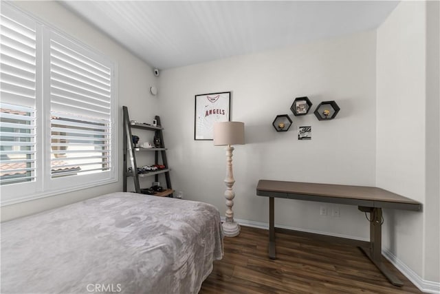 bedroom featuring wood finished floors and baseboards