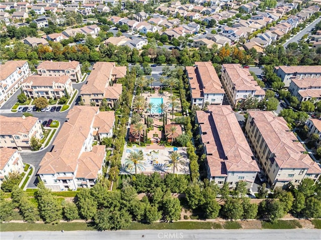aerial view of property and surrounding area featuring nearby suburban area