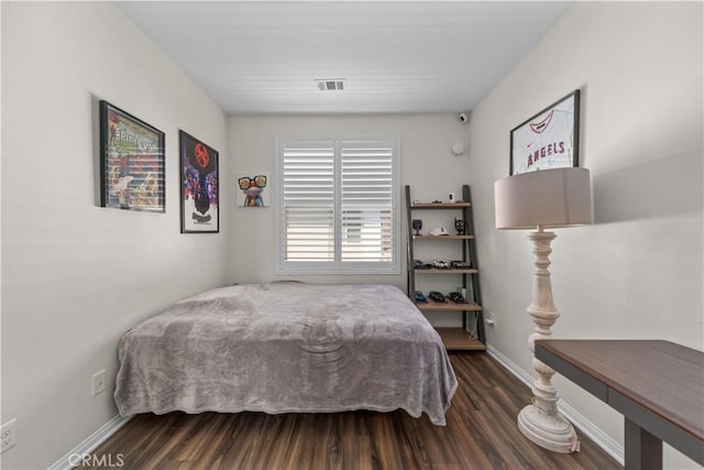 bedroom featuring dark wood finished floors and baseboards