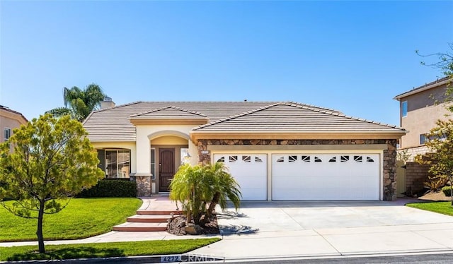 4272 Castlepeak Dr, Corona, CA 92883 - view of front of home featuring concrete driveway, stone siding, an attached garage, a tile roof, and a chimney