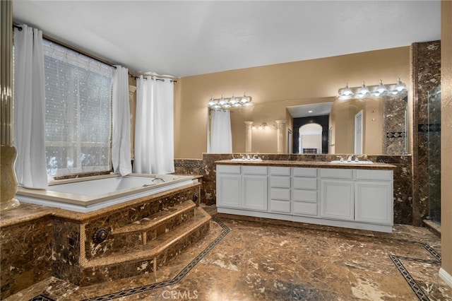 full bathroom featuring double vanity and a garden tub