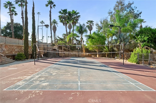 view of property's community featuring volleyball court and fence