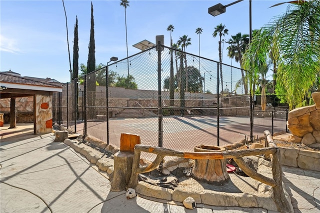 view of tennis court with fence