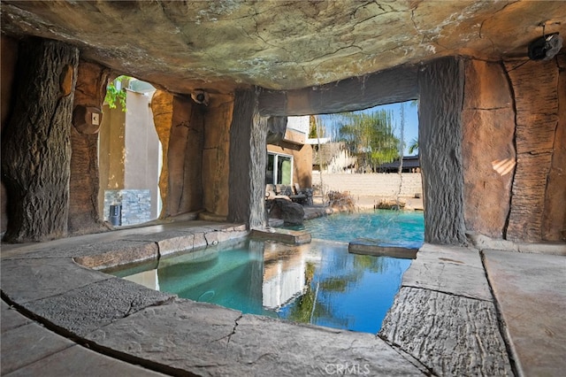 view of swimming pool with a pool with connected hot tub