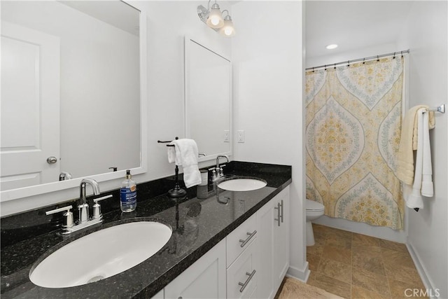 36936 Buccella Ln, Beaumont, CA 92223 - bathroom featuring double vanity, toilet, curtained shower, baseboards, and recessed lighting