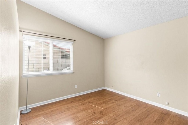 1866 Overland St, Colton, CA 92324 - empty room featuring wood finished floors, vaulted ceiling, and a textured ceiling