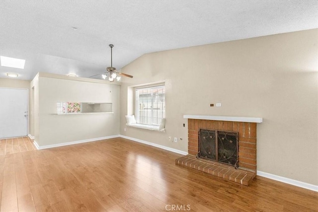1866 Overland St, Colton, CA 92324 - unfurnished living room featuring wood finished floors, vaulted ceiling, a ceiling fan, and a fireplace
