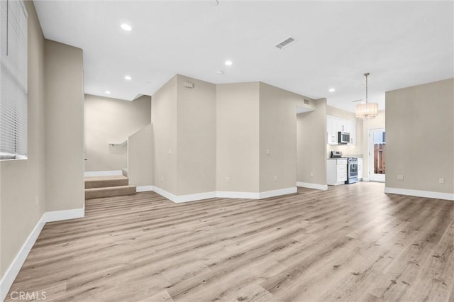 547 N Wilson Ave Unit 2, Pasadena, CA 91106 - unfurnished living room featuring light wood-style flooring, baseboards, recessed lighting, and stairway