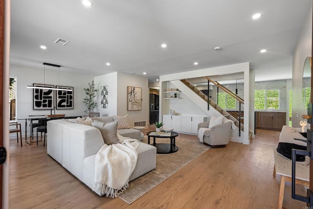 4687 Murat Ct, San Diego, CA 92117 - living area with stairs, wood finished floors, and recessed lighting