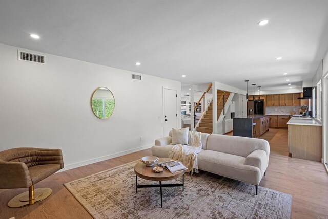 4687 Murat Ct, San Diego, CA 92117 - living area with stairs, recessed lighting, and light wood-style floors