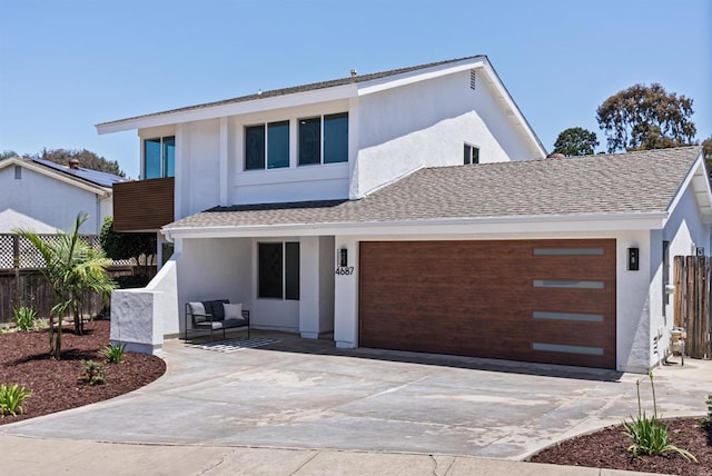 4687 Murat Ct, San Diego, CA 92117 - modern home featuring driveway, an attached garage, stucco siding, and roof with shingles