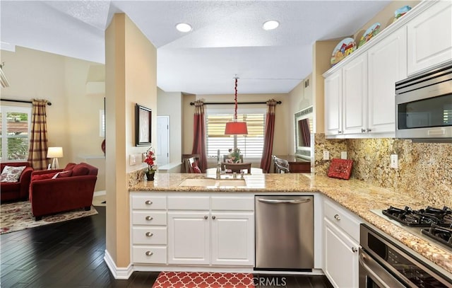 5126 E Paddington Ct Unit F, Orange, CA 92867 - kitchen with appliances with stainless steel finishes, a sink, dark wood-style floors, white cabinets, and light stone counters