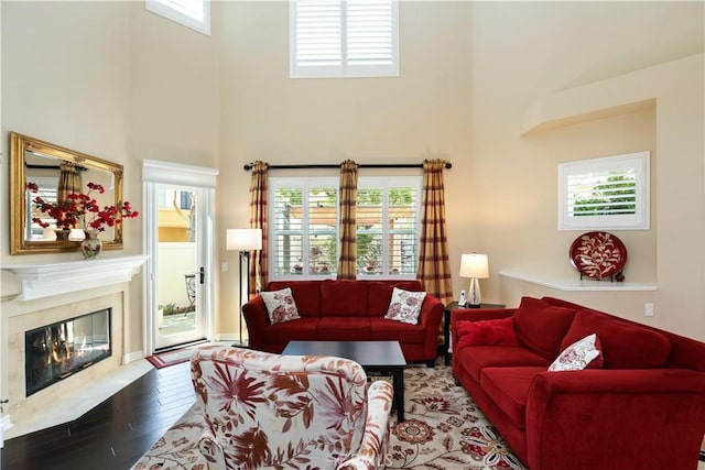 5126 E Paddington Ct Unit F, Orange, CA 92867 - living room with a towering ceiling, wood finished floors, and a fireplace
