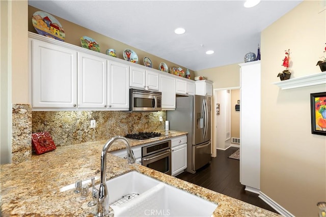 5126 E Paddington Ct Unit F, Orange, CA 92867 - kitchen featuring appliances with stainless steel finishes, dark wood finished floors, a sink, white cabinets, and recessed lighting