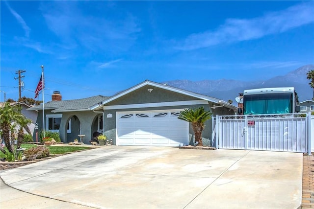 9914 Albany Ave, Rancho Cucamonga, CA 91701 - ranch-style house with stucco siding, driveway, a mountain view, a garage, and a chimney