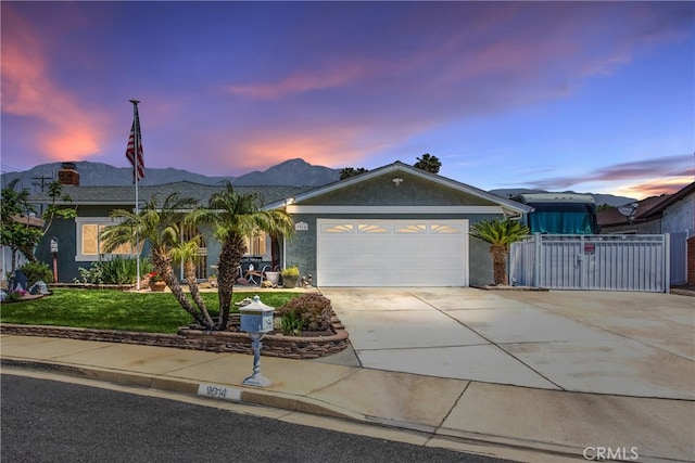 9914 Albany Ave, Rancho Cucamonga, CA 91701 - ranch-style house with concrete driveway, a garage, stucco siding, and a mountain view
