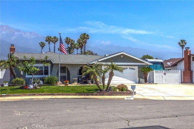 9914 Albany Ave, Rancho Cucamonga, CA 91701 - ranch-style house featuring a mountain view, concrete driveway, a gate, and an attached garage