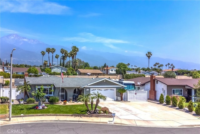 9914 Albany Ave, Rancho Cucamonga, CA 91701 - ranch-style home featuring a gate, a residential view, a mountain view, concrete driveway, and an attached garage