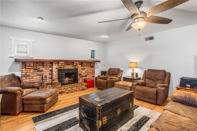 9914 Albany Ave, Rancho Cucamonga, CA 91701 - living room with light wood-style floors, ceiling fan, and a brick fireplace