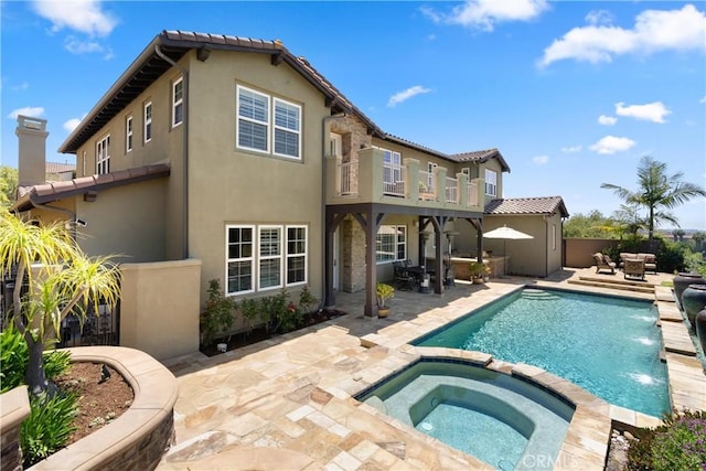 27371 Via Priorato, San Juan Capistrano, CA 92675 - rear view of house with a balcony, stucco siding, a patio, a pool with connected hot tub, and a tiled roof