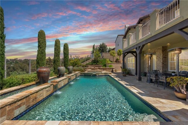 27371 Via Priorato, San Juan Capistrano, CA 92675 - pool at dusk featuring a patio and a pool with connected hot tub