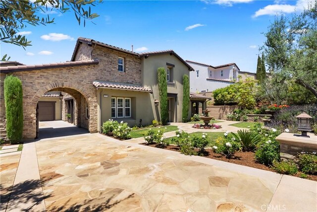 27371 Via Priorato, San Juan Capistrano, CA 92675 - mediterranean / spanish-style home with a tiled roof, stone siding, stucco siding, and concrete driveway