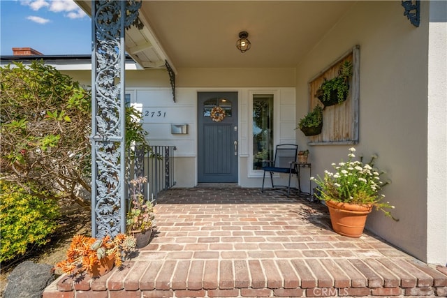 2731 N Rutgers Ave, Long Beach, CA 90815 - doorway to property featuring stucco siding and covered porch