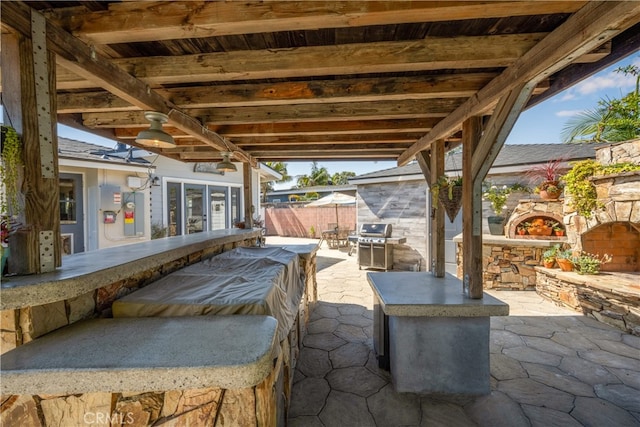 2731 N Rutgers Ave, Long Beach, CA 90815 - view of patio with fence, an outdoor stone fireplace, and area for grilling