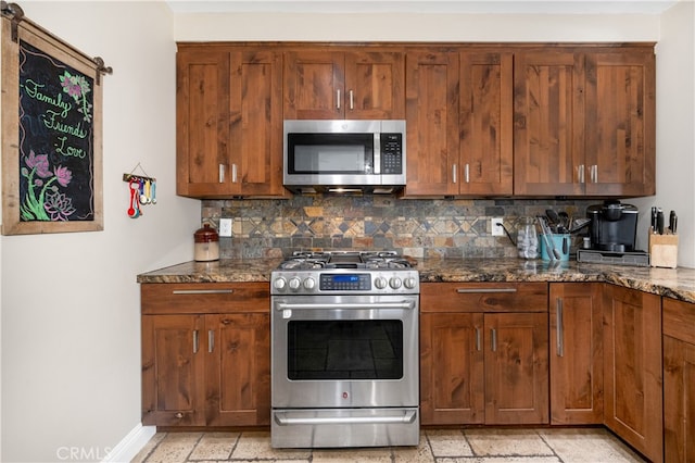 2731 N Rutgers Ave, Long Beach, CA 90815 - kitchen with stainless steel appliances, tasteful backsplash, dark stone counters, and brown cabinetry